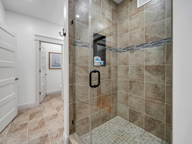 bathroom with tile patterned flooring and walk in shower