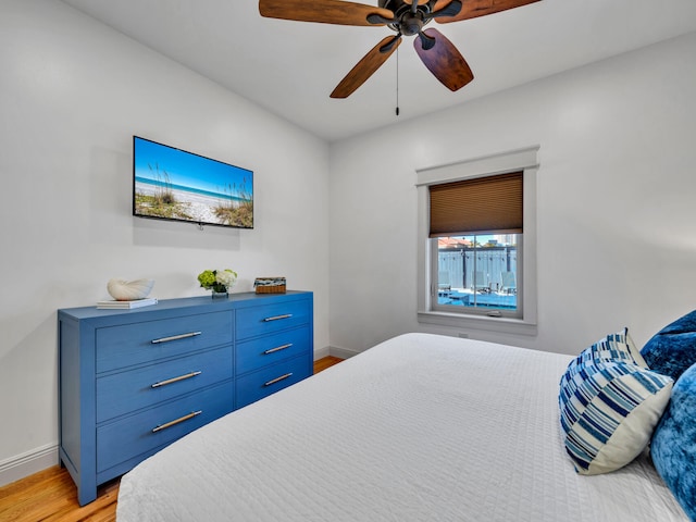 bedroom with ceiling fan and light hardwood / wood-style floors