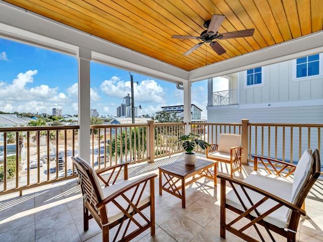 sunroom / solarium featuring ceiling fan and wood ceiling