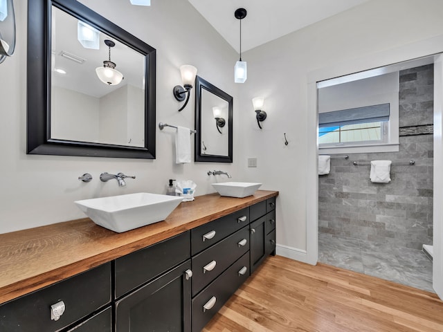 bathroom featuring vanity, a shower, and hardwood / wood-style floors