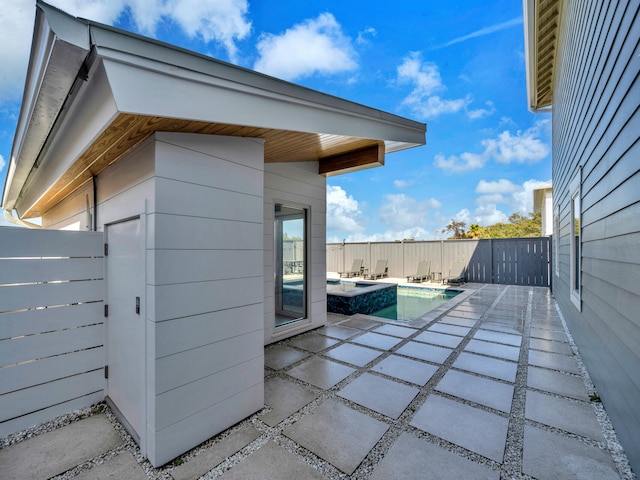 exterior space with a fenced in pool and a patio area