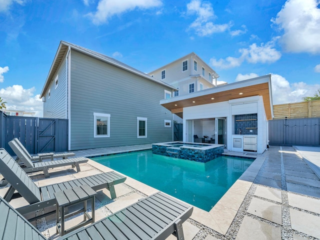 view of pool featuring an in ground hot tub and a patio area