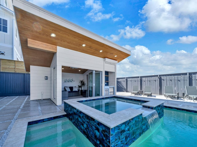 view of swimming pool featuring an in ground hot tub and a patio