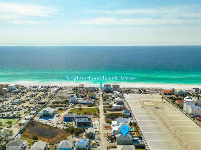 bird's eye view featuring a water view and a beach view