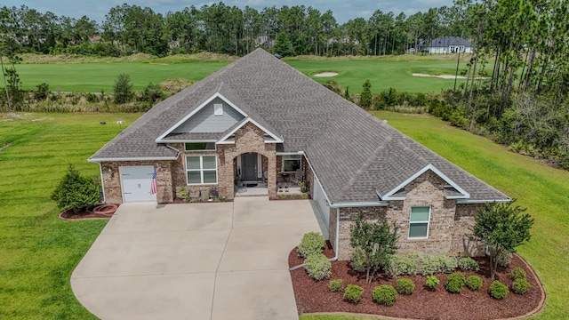 132 Gulf Pines Ct, Freeport, FL 32439 - craftsman inspired home featuring brick siding, golf course view, a front yard, a garage, and a shingled roof