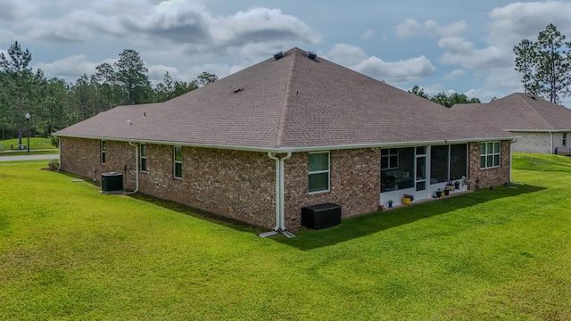 132 Gulf Pines Ct, Freeport, FL 32439 - rear view of house with central AC unit, roof with shingles, and a yard