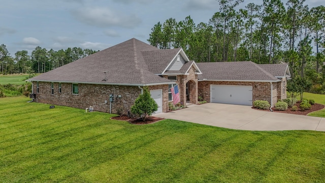 132 Gulf Pines Ct, Freeport, FL 32439 - view of front facade with a garage, brick siding, driveway, a shingled roof, and a front lawn