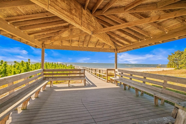 wooden terrace with a water view and a beach view