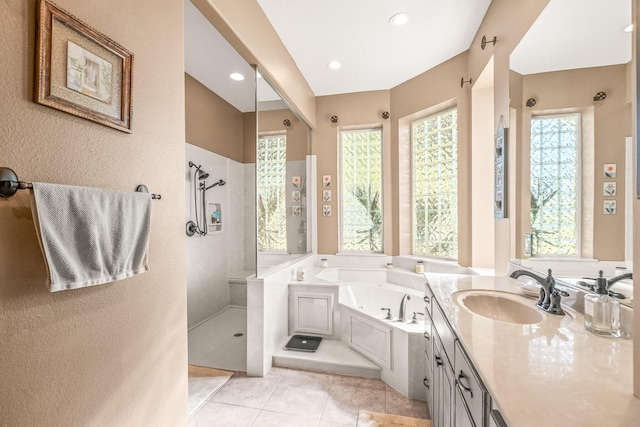 bathroom with tile patterned floors, shower with separate bathtub, and vanity