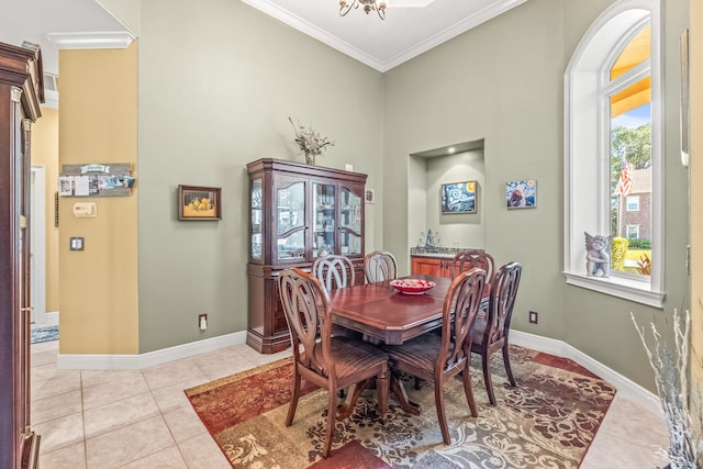 dining area featuring ornamental molding and light tile patterned flooring