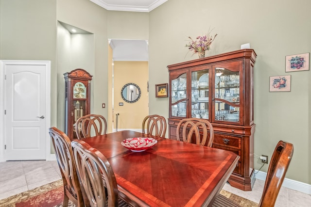 tiled dining space featuring crown molding