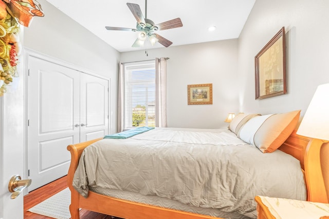 bedroom featuring ceiling fan, hardwood / wood-style floors, and a closet