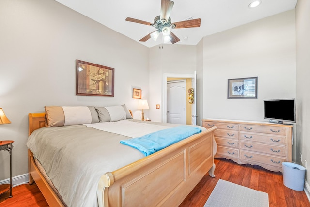 bedroom with ceiling fan and dark hardwood / wood-style flooring