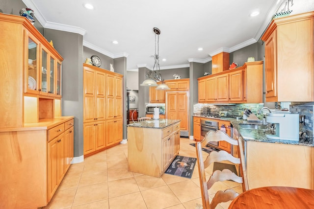 kitchen with sink, dark stone counters, hanging light fixtures, a center island, and light tile patterned floors