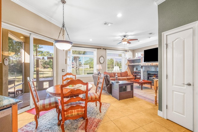 dining room with ornamental molding, ceiling fan, and light tile patterned flooring