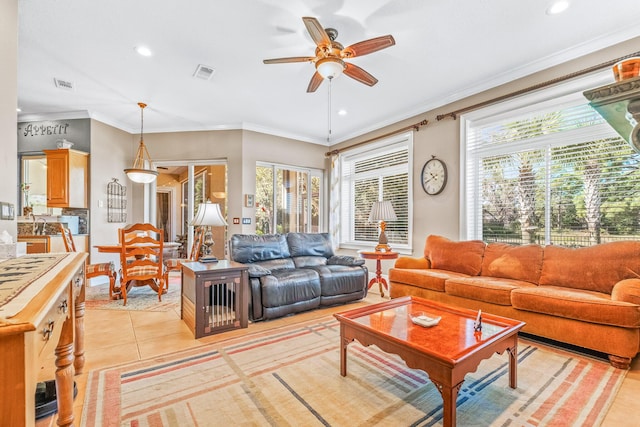 tiled living room featuring ornamental molding and ceiling fan