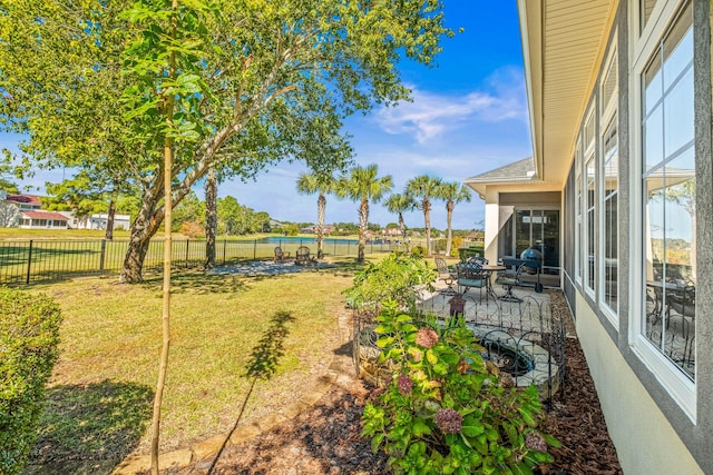 view of yard featuring a patio area and a water view