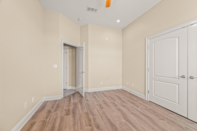 unfurnished bedroom featuring baseboards, ceiling fan, light wood-style flooring, and visible vents
