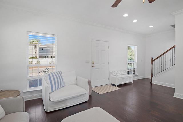 living room featuring hardwood / wood-style flooring, plenty of natural light, stairs, and ornamental molding