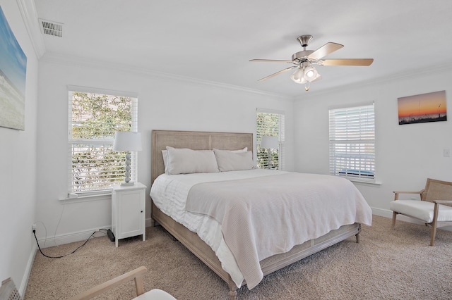 bedroom featuring baseboards, visible vents, ceiling fan, ornamental molding, and carpet floors