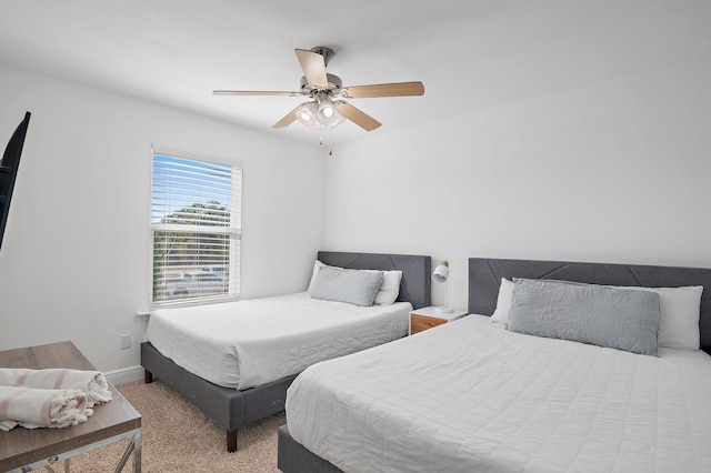 carpeted bedroom featuring ceiling fan and baseboards