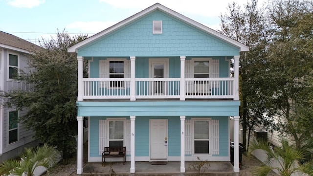 view of front of property with covered porch and a balcony