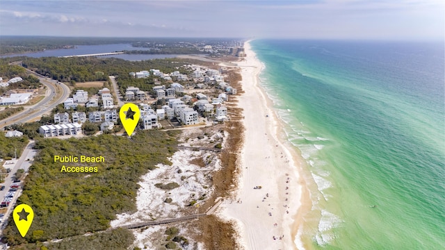 bird's eye view with a water view and a beach view