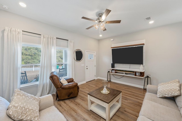 living room with ceiling fan and hardwood / wood-style floors