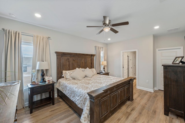 bedroom featuring ceiling fan, connected bathroom, and light wood-type flooring