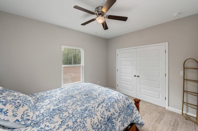 bedroom with a closet, ceiling fan, and carpet flooring