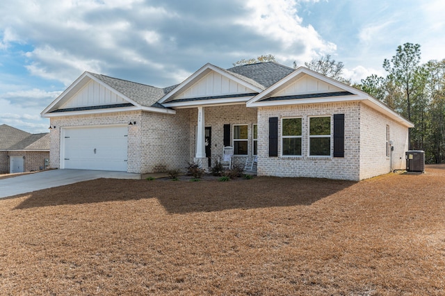 view of front facade with a garage, covered porch, and central air condition unit