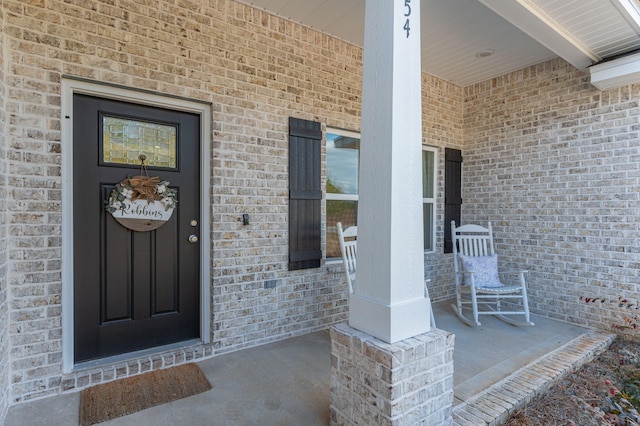 view of exterior entry featuring a porch