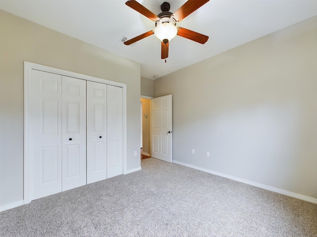 unfurnished bedroom featuring ceiling fan, carpet floors, and a closet