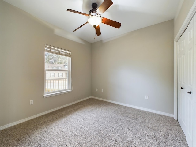 spare room with light carpet and ceiling fan