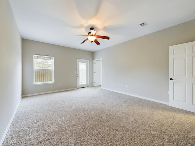 empty room featuring carpet floors and ceiling fan