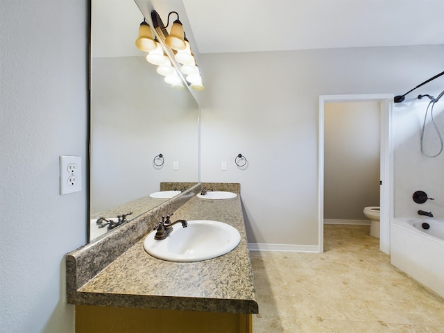 full bathroom featuring vanity, toilet, and  shower combination