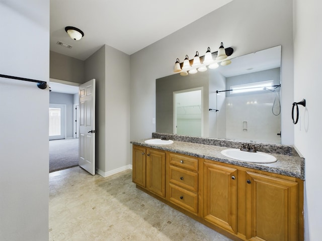 bathroom with vanity, a wealth of natural light, and a shower