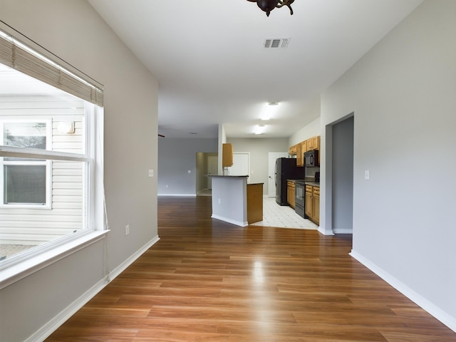 unfurnished living room featuring light hardwood / wood-style flooring and plenty of natural light