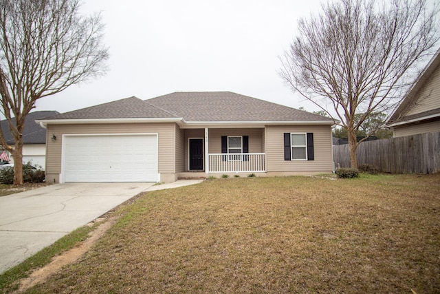 ranch-style home featuring covered porch, a front yard, and a garage