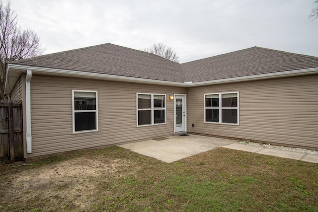 rear view of house with a patio area and a lawn