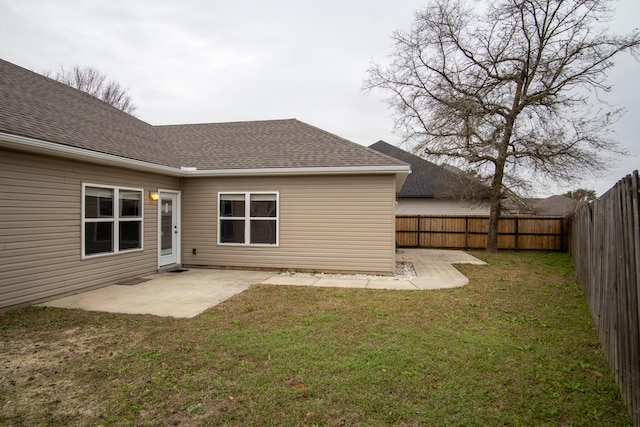 rear view of property featuring a patio and a lawn