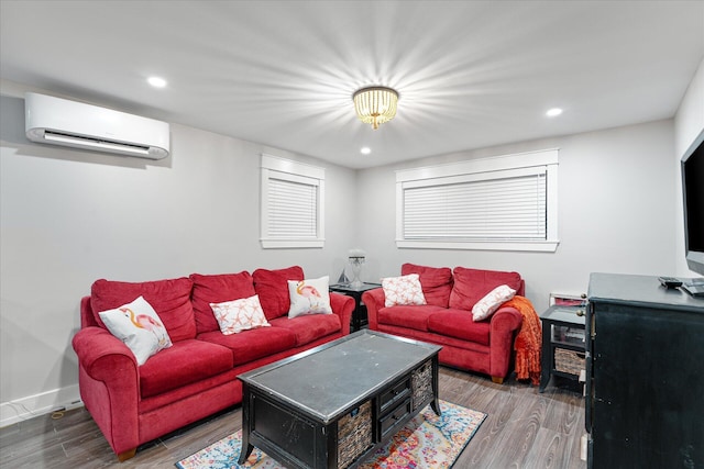 living room with recessed lighting, baseboards, an AC wall unit, and wood finished floors