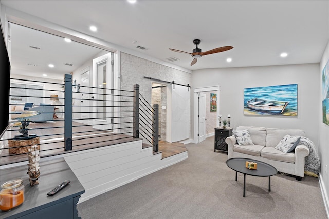 living area featuring a barn door, recessed lighting, carpet floors, visible vents, and a ceiling fan