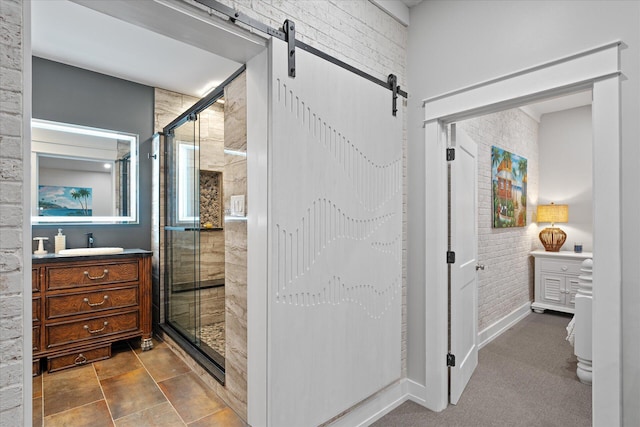 bathroom with brick wall, vanity, and a shower stall