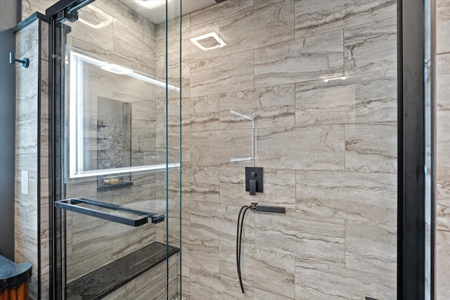 bathroom with a stall shower and visible vents