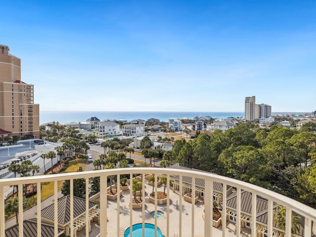 balcony with a patio area, a water view, and a city view