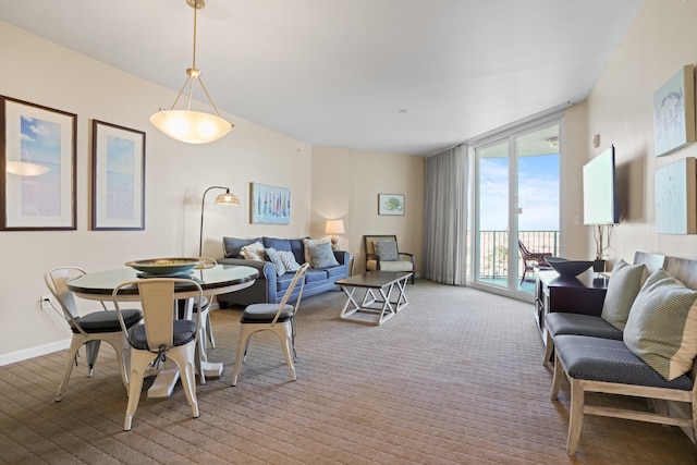 carpeted dining room featuring expansive windows