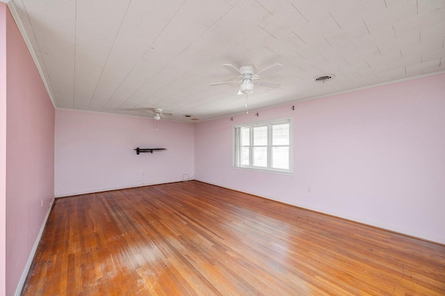 empty room featuring hardwood / wood-style flooring and ceiling fan