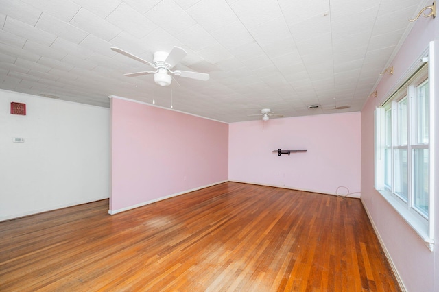 empty room featuring hardwood / wood-style flooring and ceiling fan