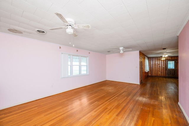 spare room featuring wood-type flooring and ceiling fan